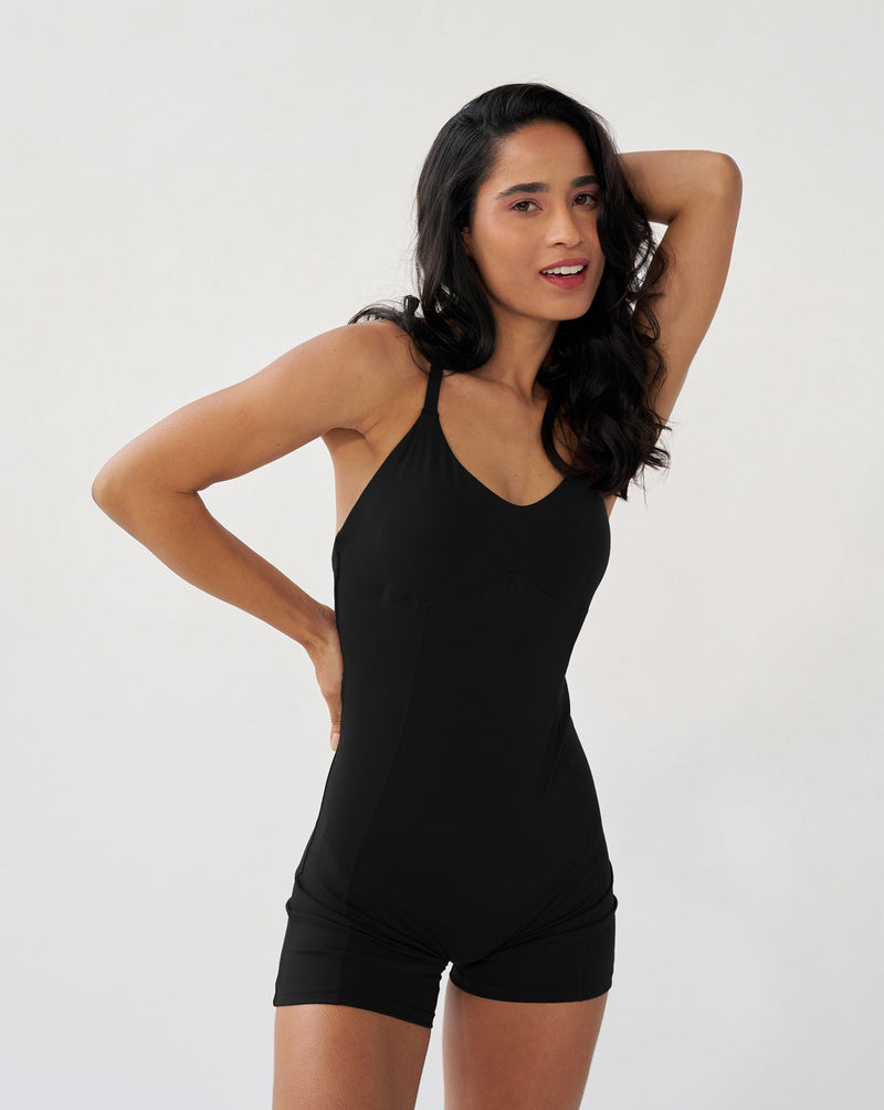 Black Corset Bodysuit with built-in bra, featuring adjustable criss cross straps and a deep scoop back, ideal for yoga or strength training